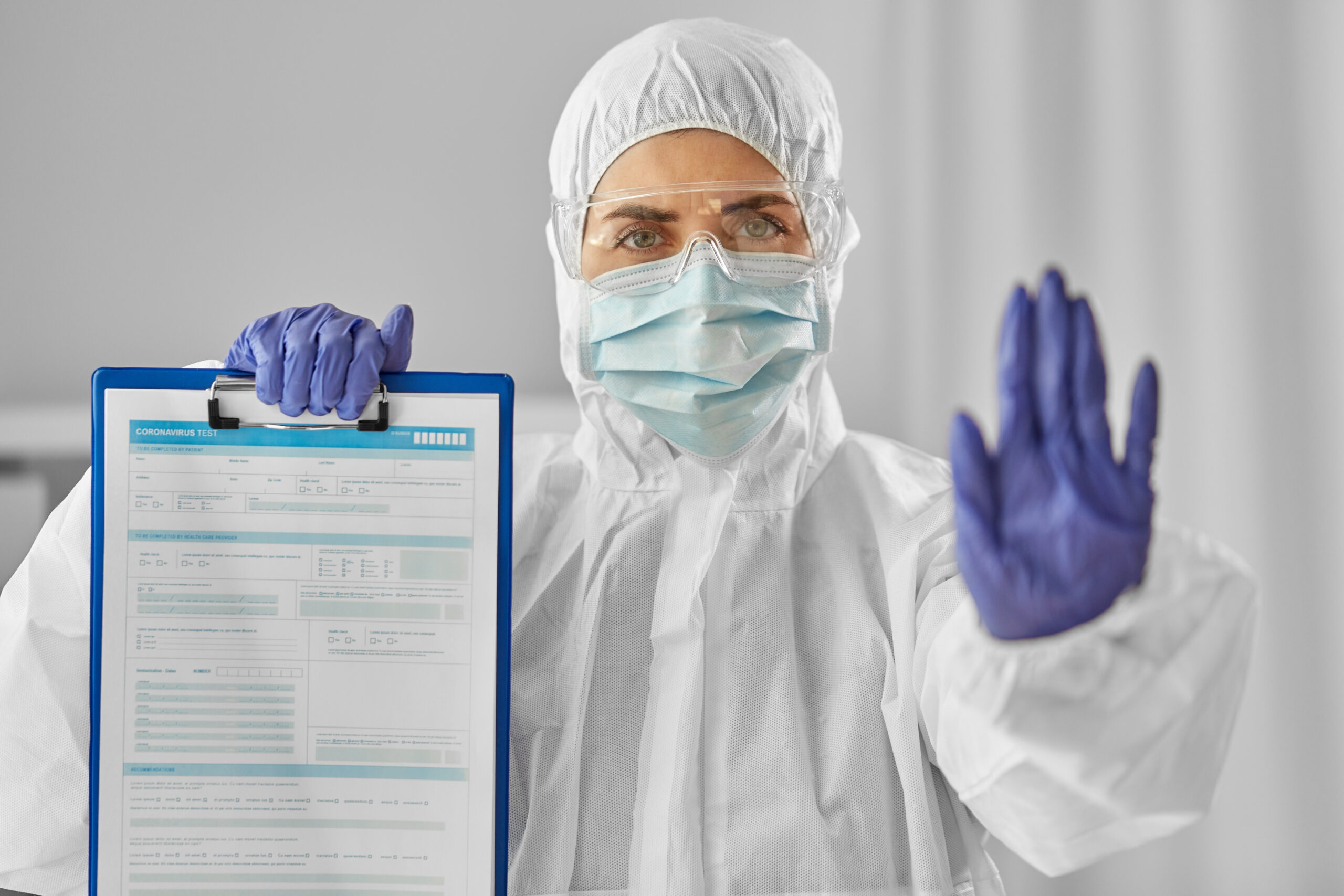 doctor in medical mask and goggles with clipboard